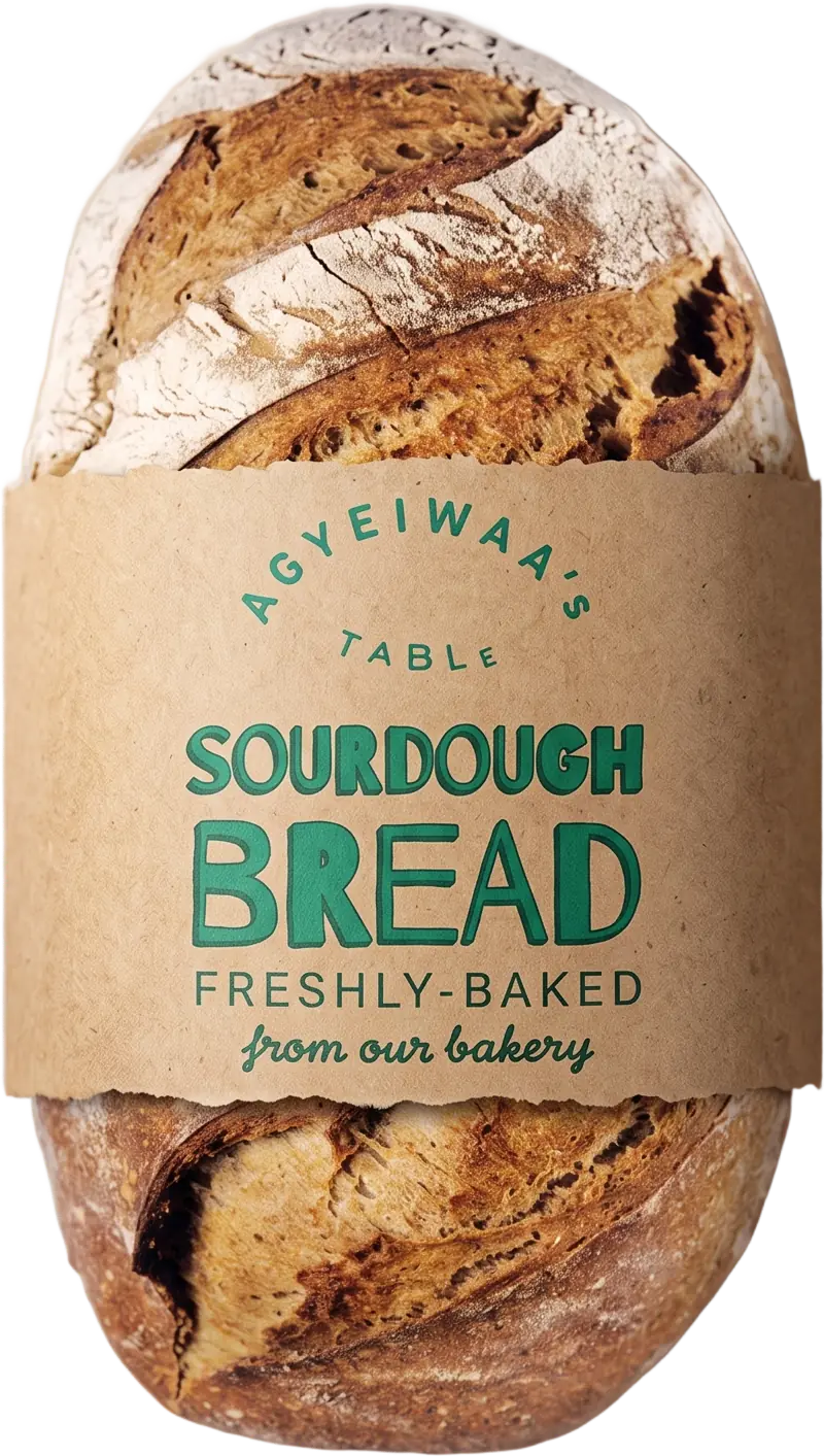 A loaf of Agyeiwaa's Table sourdough bread in a kraft paper wrap. The label reads &ldquo;Sourdough Bread, freshly-baked from our bakery&rdquo;