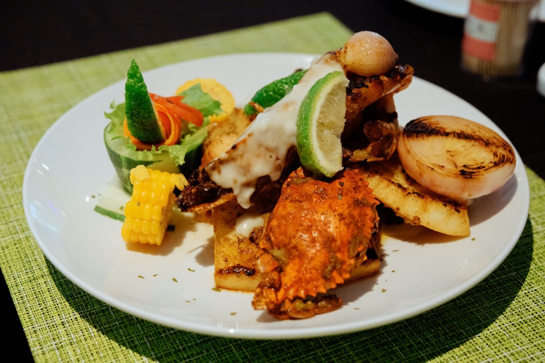 Grilled seafood platter with crab, calamari, salad and corn