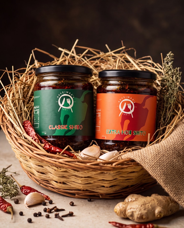 Jars of Agyeiwaa's Table Classic Shito and Extra Hot Shito in a woven basket with dried chillies, garlic and ginger